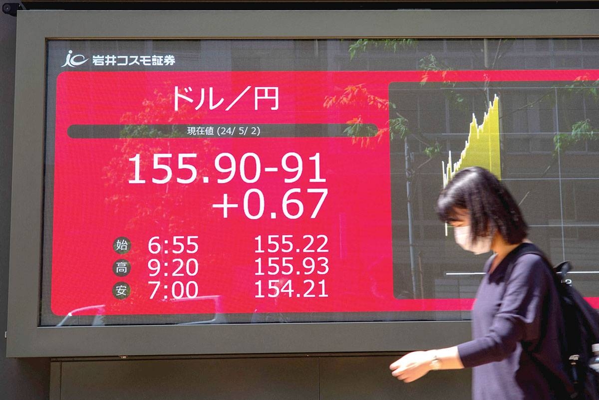 INTERVENTION A woman walks in front of an electronic board displaying the exchange rate for the Japanese yen against the US
dollar in Tokyo on Thursday, May 2, 2024. AFP PHOTO