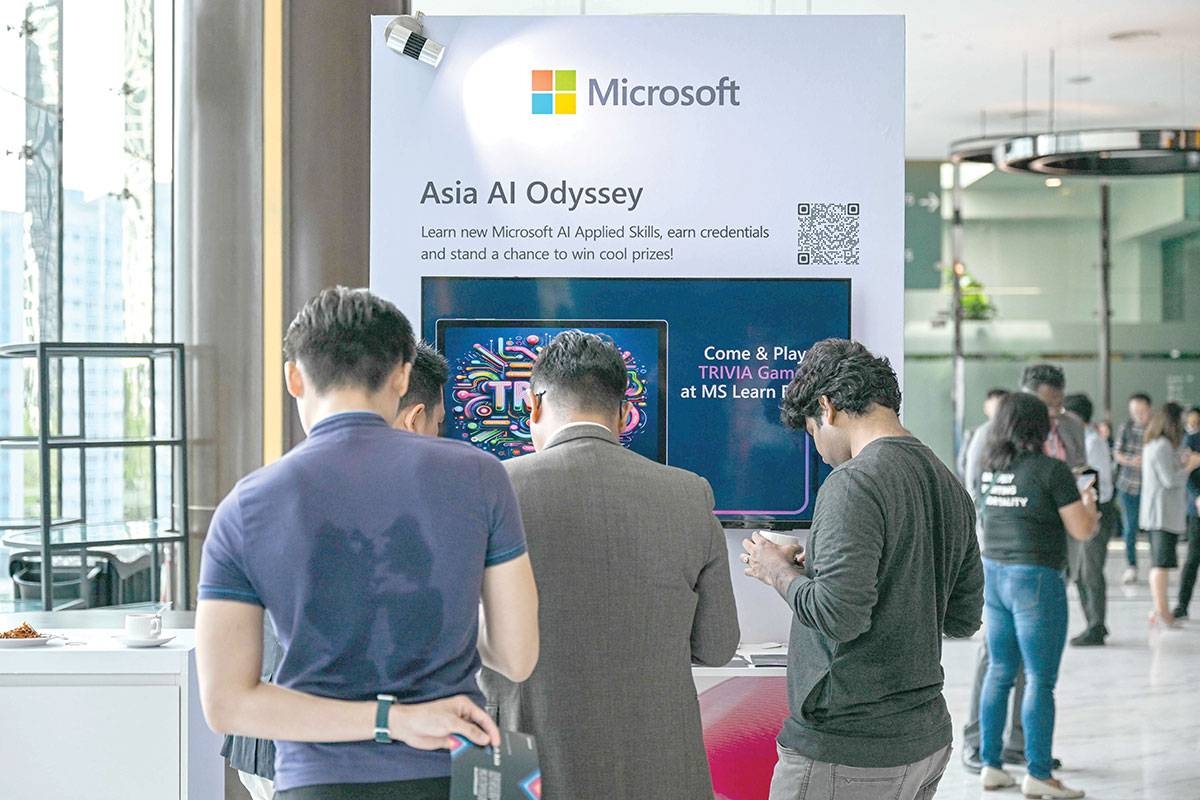 BROWSING Participants check a Microsoft booth before CEO Satya Nadella’s speech during an event named Microsoft Build AI Day in Kuala Lumpur on Thursday, May 2, 2024. Microsoft said on Thursday it will invest $2.2 billion to develop Malaysia’s AI infrastructure. AFP PHOTO