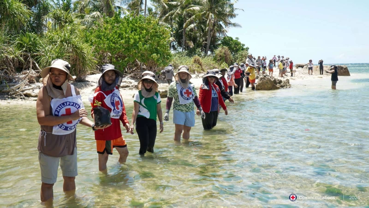 Members of the Philippine Red Cross and Bohol communities participate in the mangrove restoration initiative in Bonkokan Ubos in Lila, Bohol. CONTRIBUTED PHOTO