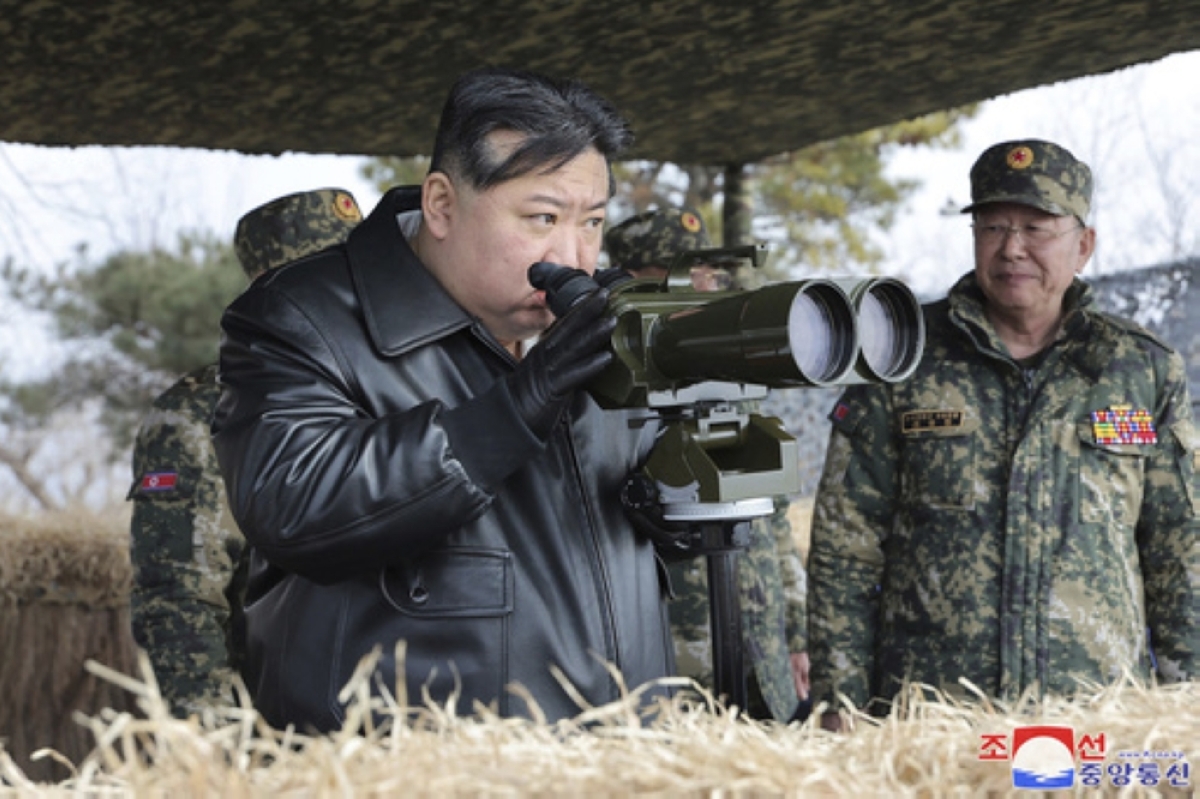 COMBAT PREPAREDNESS North Korean President Kim Jong Un supervises artillery firing drills in North Korea on Thursday, March 7, 2024. AP photo