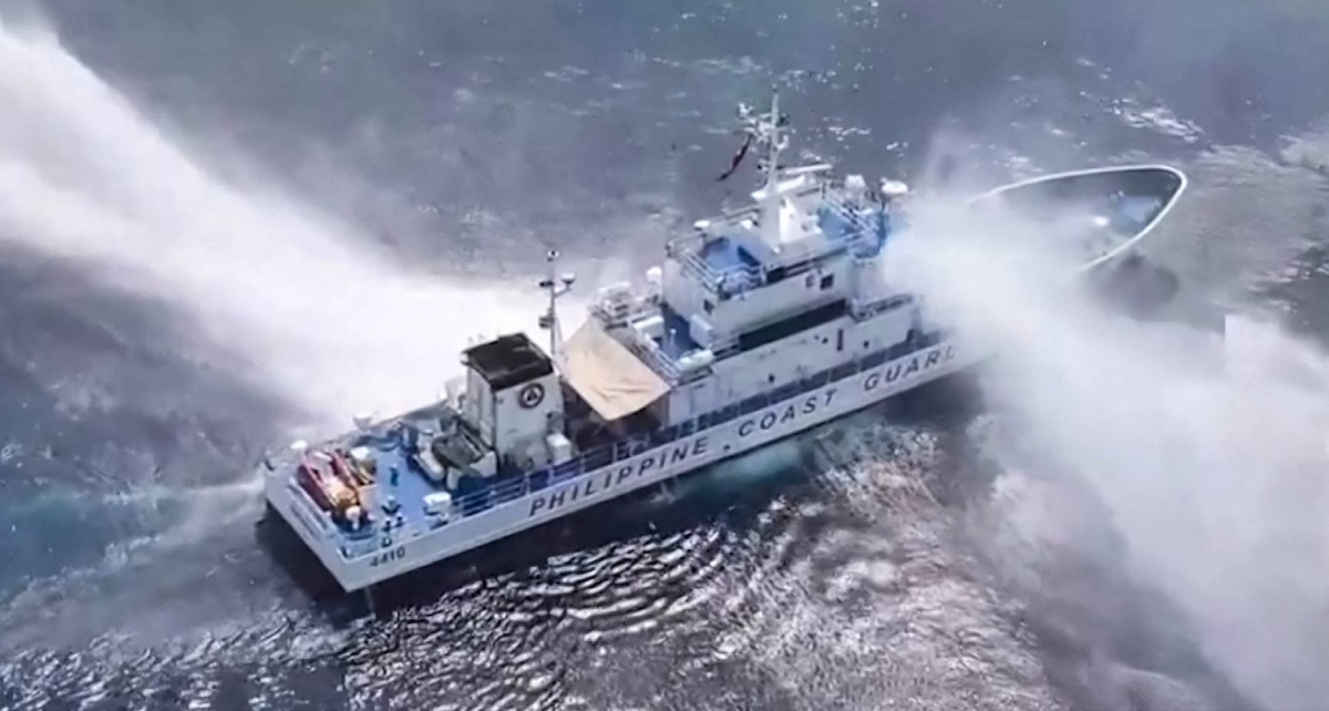 This frame grab from video footage taken and released on April 30, 2024 by the Philippine Coast Guard shows the BRP Bagacay being hit by water cannon from Chinese coast guard vessels near the Chinese-controlled Scarborough shoal in disputed waters of the South China Sea. Photo by Handout / Philippine Coast Guard (PCG)