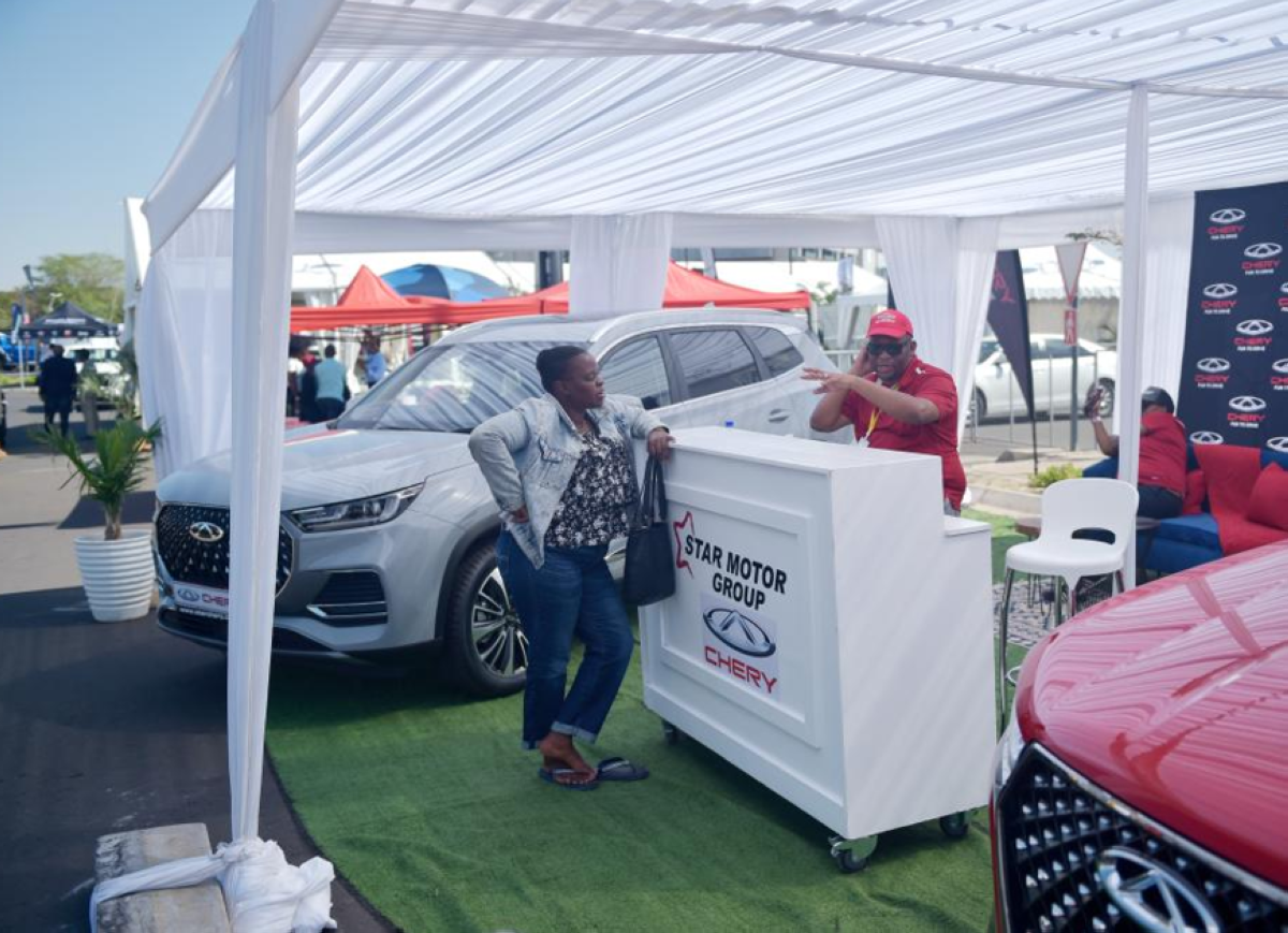 A visitor inquires about the Chery cars during the 9th edition of the Shell Gaborone Motor Show in Gaborone, Botswana, on May 3, 2024. XINHUA PHOTO