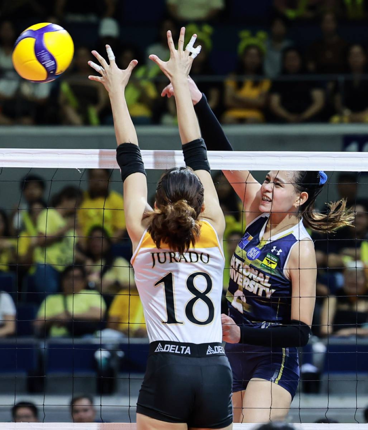 NU’s Vangie Alinsug scores against UST’s Regina Jurado during Game 1 of the UAAP Season 86 women’s volleyball finals at the Araneta Coliseum on May 11, 2024. PHOTO BY RIO DELUVIO
