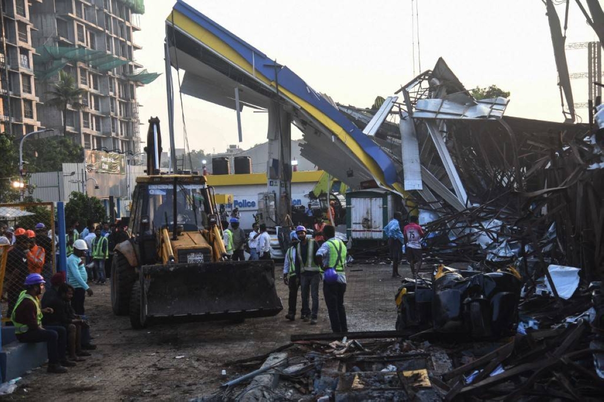 TOUGH TASK Emergency personnel gather at a gasoline station, where a billboard collapsed on it the day before, in the city of Mumbai, western India, on May 14, 2024. AFP PHOTO