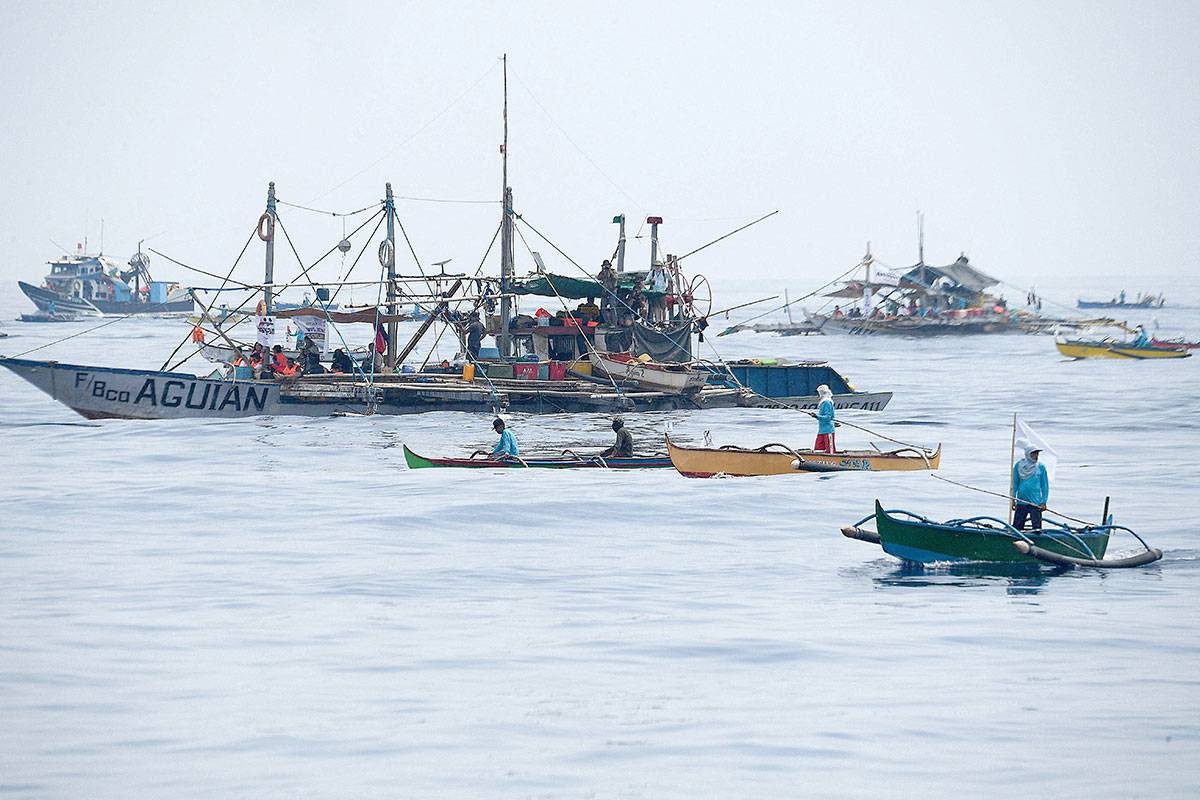 OFF THEY GO Philippine fishermen, along with volunteers from the civilian-led mission Atin Ito (It’s Ours) Coalition aboard fishing boats, at a meeting point in the South China Sea on May 15, 2024. AFP PHOTO