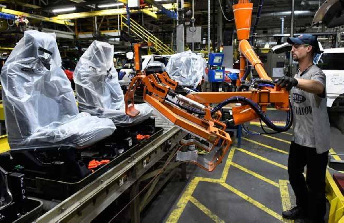 In this Oct. 27, 2017 photo, workers assemble Ford trucks at the Ford Kentucky Truck Plant in Louisville, Kentucky. US manufacturers grew at a slower pace in May, as production levels fell slightly. AP FILE PHOTO