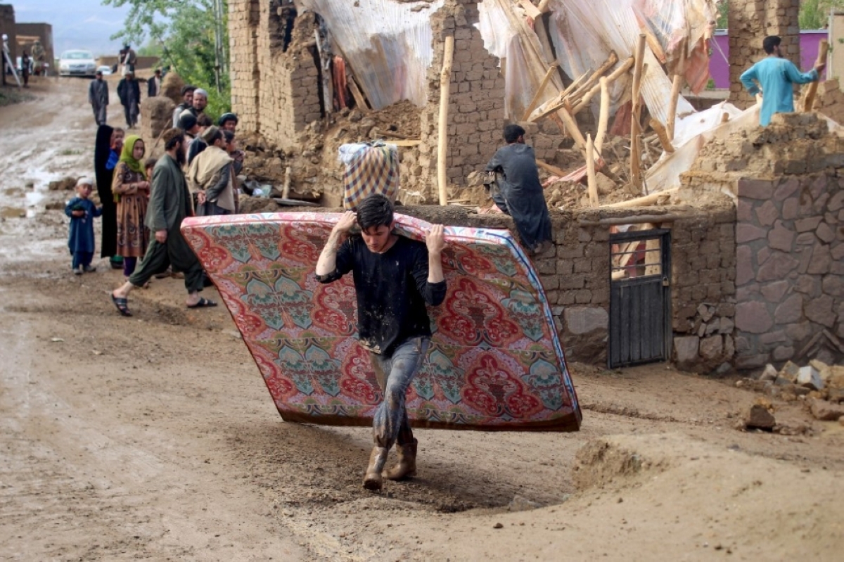 WEATHER WOES A young Afghan man carries a soiled mattress as residents try to salvage their belongings at a flood-damaged house in the city of Firozkoh, Ghor province, western Afghanistan on May 18, 2024. AFP PHOTO