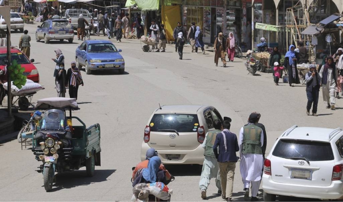 People and vehicles are seen at a market near the scene of a shooting that left at least six people, including three Spanish tourists, dead the day before in the city of Bamiyan, Bamiyan province, central Afghanistan on May 18, 2024. XINHUA PHOTO