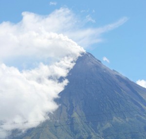 BEAUTIFUL BUT DEADLY  Mayon volcano spews a thick column of ash on Tuesday. The eruption killed four foreign tourists drawn by the beauty of Mayon, one of the most active volcanoes in the country. AFP PHOTO 