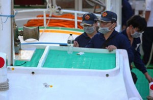 aiwanese police officers inspect bullet holes (bottom centre L) on the damaged 