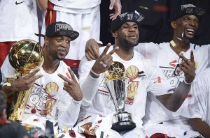Dwyane Wade (left), LeBron  James (center) and Chris Bosh (right) of the Miami Heat celebrate winning Game 7 of the NBA Finals at the American Airlines Arena in Miami, Florida. The Miami Heat, led by NBA Most Valuable Player LeBron James, won the NBA Finals for the second consecutive year by defeating the San Antonio Spurs 95-88 in game seven of the championship series. AFP PHOTO
