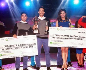 OPM@Pagcor 3 grand winner Karl Aris Tanhueco (center) with second place winner Shane Anja Tarun (right) and third placer Harriz Dover Battung (eft) during the singing search’s grand finals night