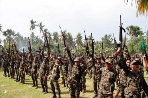 This photo taken on October 15, 2012 shows members of the Moro Islamic Liberation Front (MILF) rebels raising their rifles during a ceremony at Camp Darapanan in Sultan Kudarat, Maguindanao province on the southern Philippine. AFP file photo 