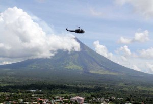 A Philippine Air Force helicopter orbits near the crater of Mayon volcano during an aerial survey. Phivolcs officials are conducting a thorough study following the restive condition of Mount Mayon whose crater has been intensely glowing for the past few months after the occurrence of phreatic explosion on May 7 this year. PHOTO BY RHAYDZ B. BARCIA 