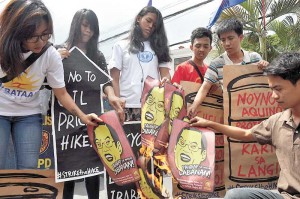 Members of Bagong Alyansang Makabayan plant placards in front of the Pandacan oil depot in Manila on Tuesday to denounce the P1.60 price increase implemented by oil companies yesterday. Photo By Edwin Muli