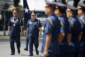 Newly-installed Metro Manila Police chief Marcelo Garbo Jr. (left) is escorted by Quezon City Police District Director Richard Albano on Tuesday as he arrives at Camp Karingal for a command conference to discuss security preparations for the opening of Congress. Photo By Miguel De Guzman