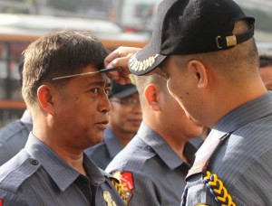 A member of the Quezon City police gets a trim from his superior in compliance with the directive of the new Metro Manila police director Chief Supt. Marcelo Garbo Jr. to require all officers in his command to look neat and presentable. Photo by Mike de Juan 