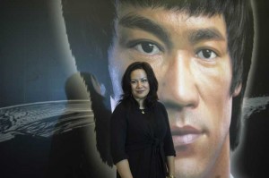 Shannon Lee, daughter of the late martial arts icon and film actor Bruce Lee poses in front of the photo of her father.  AFP PHOTO