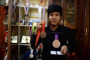 Afghanistan’s only Olympic medalist, taekwondo star and national hero Rohullah Nikpa , 26, displays his bronze medal at his residence in Kabul. AFP PHOTO