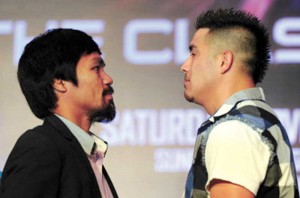 Manny Pacquiao (L) and Brendon Rios pose for photographers during a pre-fight press conference in Macau on July 27, 2013. AFP PHOTO