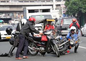 Two Metropolitan Manila Development Authority traffic enforcers and a lone motorcyclist collided in the middle of Kamuning Street in Quezon City, causing a minor traffic jam on Friday.  Photo By Mike De Juan