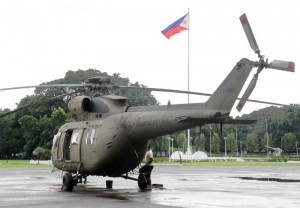 One of the eight new Sokol helicopters acquired by the Philippine military remains in the grandstand fronting the AFP headquarters in Camp Aguinaldo, Quezon City, where it made an emergency landing last Monday because of weak batteries. A representative from the helicopter’s maker, PZL Swidnik of Poland, checked  the aircraft on Wednesday. Photo by Mike de Juan