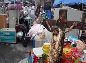 A crucifix is one of the personal belongings rescued from a fire that razed 20 houses in Pinyahan, Quezon City, on Friday. Photo by Mike de Juan