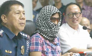 Rescued kidnap victim Sally Chua, wearing veil and sunglasses, relates to media on Friday her ordeal in the hands of her kidnappers, who snatched her in Quezon City and took her all the way to Davao City. Three of her kidnappers were killed in a shootout with police, while a fourth was apprehended. PHOTO BY MIGUEL DE GUZMAN
