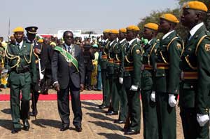 Zimbabwe President Robert Mugabe (center) arrives for a speech at the National Heroes Acre in Harare on Monday during Heroes Day celebrations. AFP PHOTO