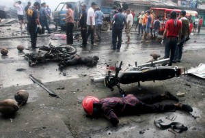 Investigators look for evidence among wreckage after a bomb explosion in Cotabato City. The powerful bomb killed six people and injured at least 26 others, police said. AFP Photo 