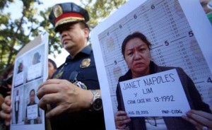 A police officer holds mug shots of Napoles. Photos Miguel De Guzman And Malacañang