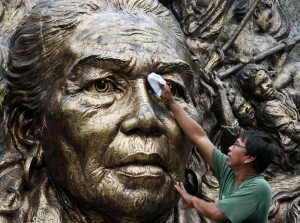 A worker cleans a huge sculpture of Tandang Sora at the Himlayang Pilipino on Monday, National Heroes Day. Photo By Mike De Juan 