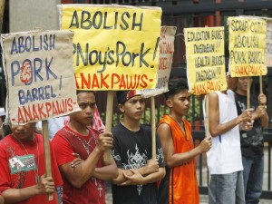 Members of militant groups stage a rally outside the House of Representatives in Quezon City on Wednesday to press their demand that the pork barrel of the President be scrapped, along with the government’s Conditional Cash Transfer program which provides a monthly stipend for poor families. Photo By Miguel De Guzman