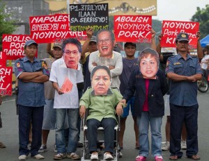 Members of the Kilusang Mayo Uno wear masks depicting President Benigno Aquino 3rd, Local Government Sec. Mar Roxas, lawyer Lorna Kapunan, and (on wheelchair) suspected pork barrel queen Janet Lim-Napoles during a rally in front of the Mendiola Peace Arch in Manila on Thursday. The rallyists called for an end to the supposed preferential treatment being accorded Napoles.   Photo By  Alexis Corpuz 