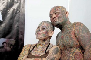 Louie Linco and Mai-Mai Leal of Maximum Tolerance Tattoo Shop display their heavily-tattooed bodies on Friday at the Tribal Gear/ Dutdutan Tattoo Festival 2013, billed as the country’s biggest exposition of the body art. The expo at the World Trade Center in Pasay City will run from Oct. 27 to 28.  Photo By Alexis Corpuz