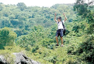 If lawmakers could have used a small part of their pork barrel to build a sturdy concrete bridge in Barangay Sibul, San Miguel, Bulacan province, Aldrin Mar Donceras won’t have to walk on a tightrope from his home to school and back. Aldrin walks the wire to cross the Bulacan river. PHOTO BY MIGUEL DE GUZMAN 