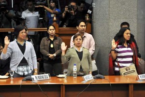 Whistleblowers (from left, foreground) Marina Sula, Mary Arlene Baltazar, and Simonette Briones take their oath before the Senate Blue Ribbon committee on Thursday.  Photo By Edwin Muli