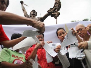 Members of the newly-formed Kilusang KonTRAPOrk tear up copies of Special Allotment Release Order during a protest rally at UP Diliman on Tuesday.  Photo By Mike De Juan