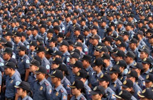 Hundreds of policemen stand at attention in Camp Crame as they wait for their deployment orders for the barangay elections on Monday.  Photo By Miguel De Guzman 