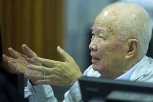 A handout photo taken and released by the Extraordinary Chamber in the Courts of Cambodia (ECCC) shows former Khmer Rouge leader head of state Khieu Samphan talking to court officials in the courtroom during trial at the ECCC in Phnom Penh on Wednesday. AFP PHOTO