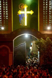 Ambulances drive through the crowd in front of the Virgin Mary Coptic Christian church in Cairo after gunmen on a motorbike shot dead three people on Sunday (Monday in Manila) in an attack on a group standing outside the church in the Egyptian capital’s Al-Warak neighborhood following a wedding ceremony. AFP PHOTO