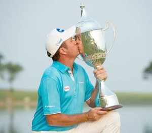 Scott Hend of Australia kisses the winners trophy after the final round of the Macau Open golf tournament. AFP PHOTO