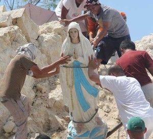 Residents remove an image of Our Lady of Lourdes from the rubble of the Holy Cross parish church in Maribojoc town, Bohol. PHOTO BY RHAYDZ BARCIA