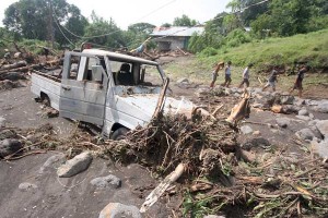 Residents of San Juan Baño in Arayat, Pampanga walk on a road littered with rocks and debris. A landslide triggered by typhoon ‘Santi’ toppled trees and sent boulders cascading to a residential area. PHOTO BY MIGUEL DE GUZMAN