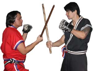 Attacker (in red) delivers a left temple strike using the cane while Punong Lakan Garitony Nicolas blocks.