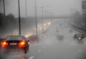 Zero visibility force motorists to turn on headlights at the North Expressway. While Metro Manila was far from the center of the super typhoon, strong rains forced schools and offices to close early. Photo By Mike De Juan
