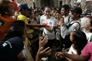  Miss World 2013 Megan Young greets typhoon survivors temporarily housed at the Redemptorist church in Tacloban City. The beauty queen encouraged them to rebuild their lives and overcome the challenges they face. PHOTO BY RENE H. DILAN 