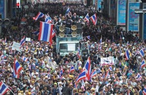 Anti-government protesters waving national flags during a demonstration in Bangkok on Monday. AFP PHOTO