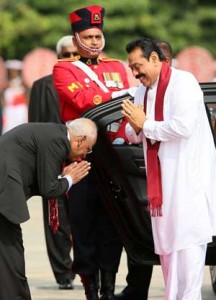 Sri Lankan President Mahinda Rajapakse (left) greeting his secretary as he arrives at the opening session of the Commonwealth Heads Of Government Meeting at the Nelum Pokuna Mahinda Rajpaksa Theatre in Colombo on Friday. AFP PHOTO