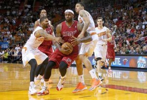 LeBron James No.6 of the Miami Heat is fouled by Gerald Green No.14 and Marcus Morris No.15 of the Phoenix Suns during a game at American Airlines Arena in Miami, Florida. AFP PHOTO